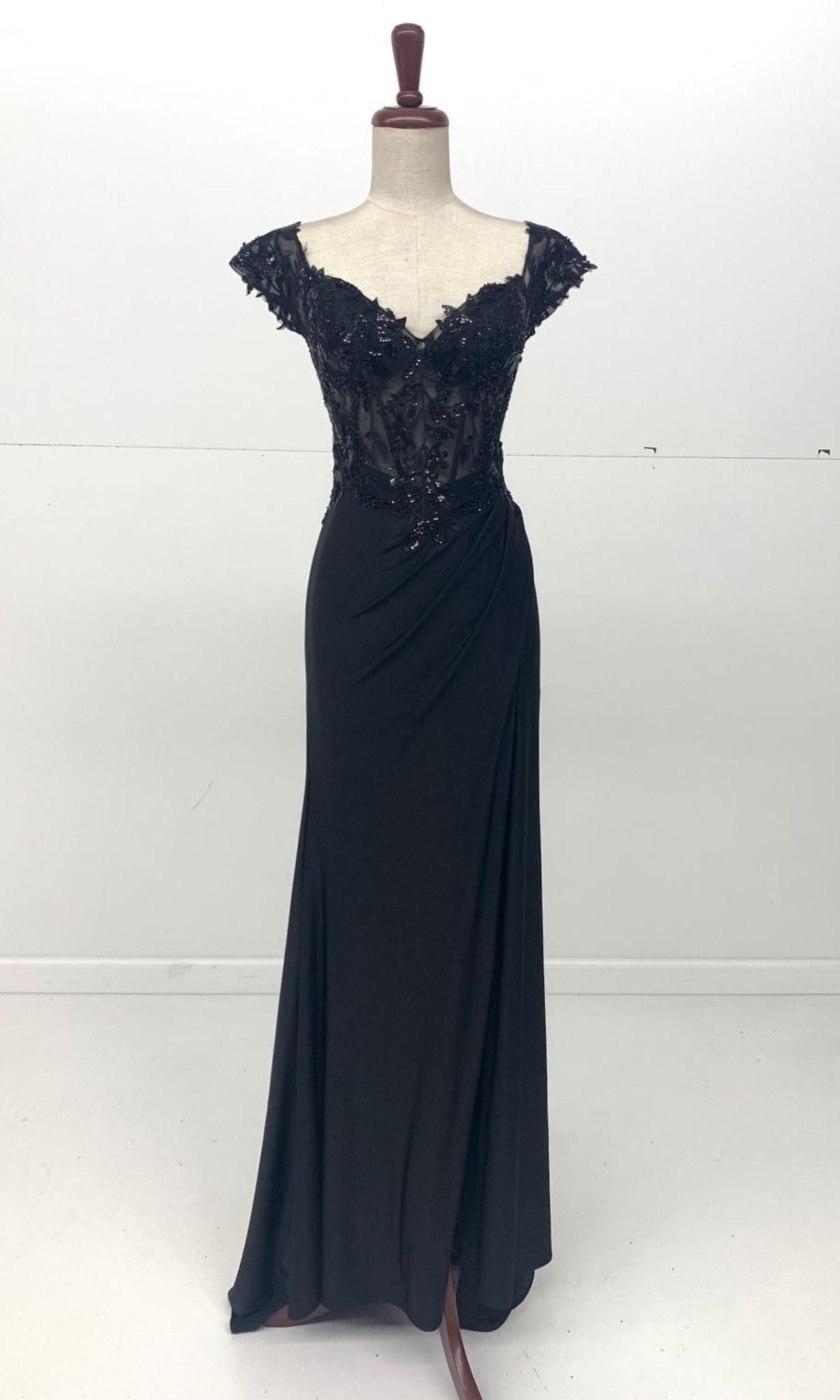 The Sequin-Bodice Long Prom Dress (Chicas YG5027) features lace cap sleeves, floral appliqué, a sequin corset bodice, and a draped floor-length skirt, shown on a dress form against a plain white background.